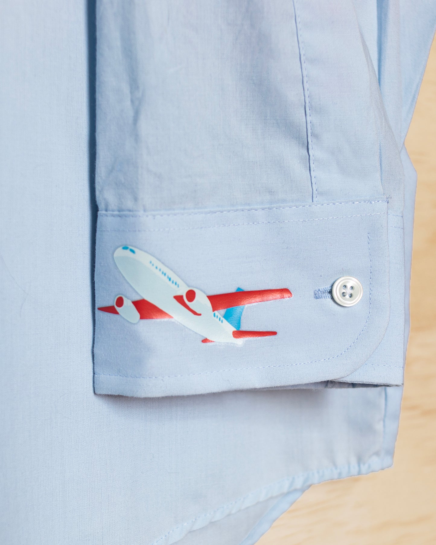 Light Blue Shirt with Plane on Sleeve